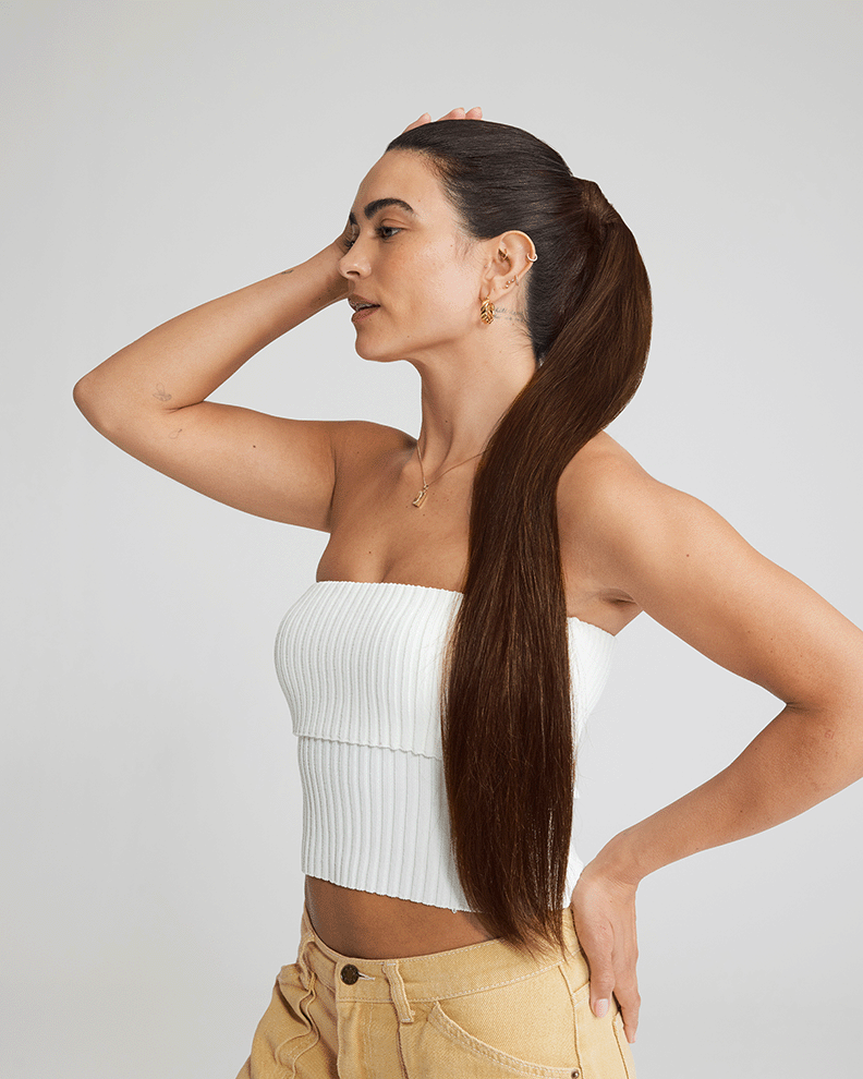 A woman with long brown hair, showcasing the back view, featuring Tape in Balayage Chestnut Dirty hair extensions.