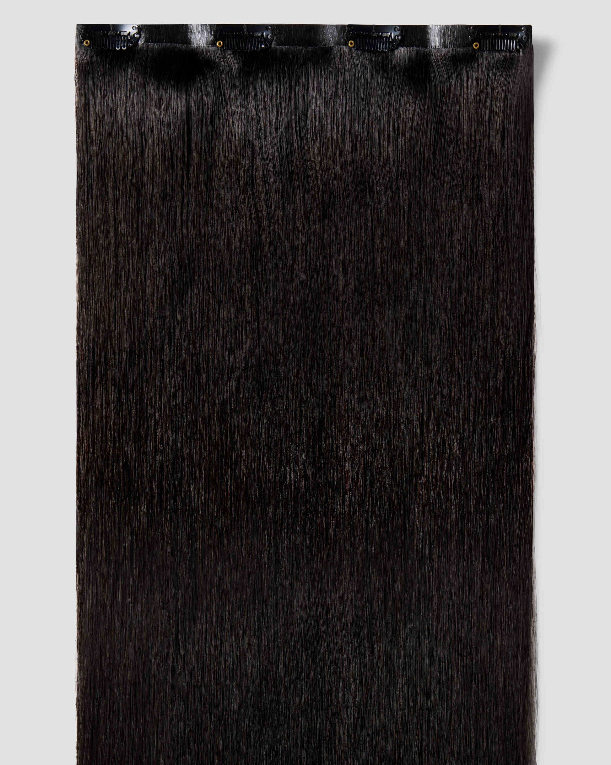 Clip-in hair extensions in black, designed to blend naturally with black hair for added volume and length.