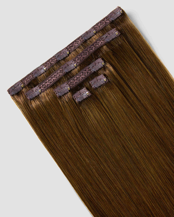 Dark brown clip-in hair extensions are displayed, showcasing a rich chestnut hue for added volume and length.