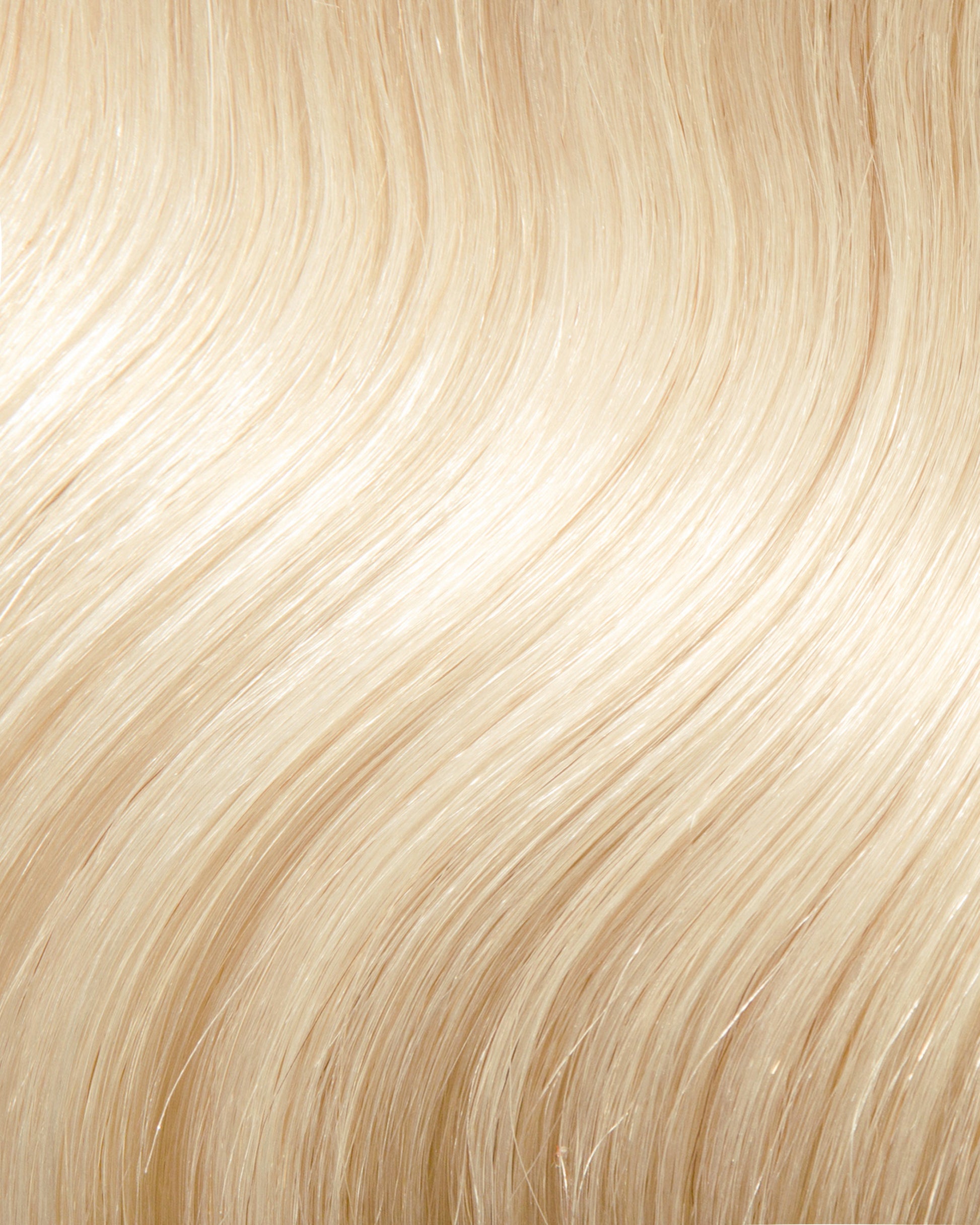 A close-up of a wavy blonde hair extension swatch.