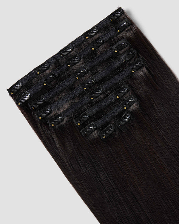 A 9 piece clip-in hair extensions in black showing the clips to blend naturally with black hair for added volume and length.