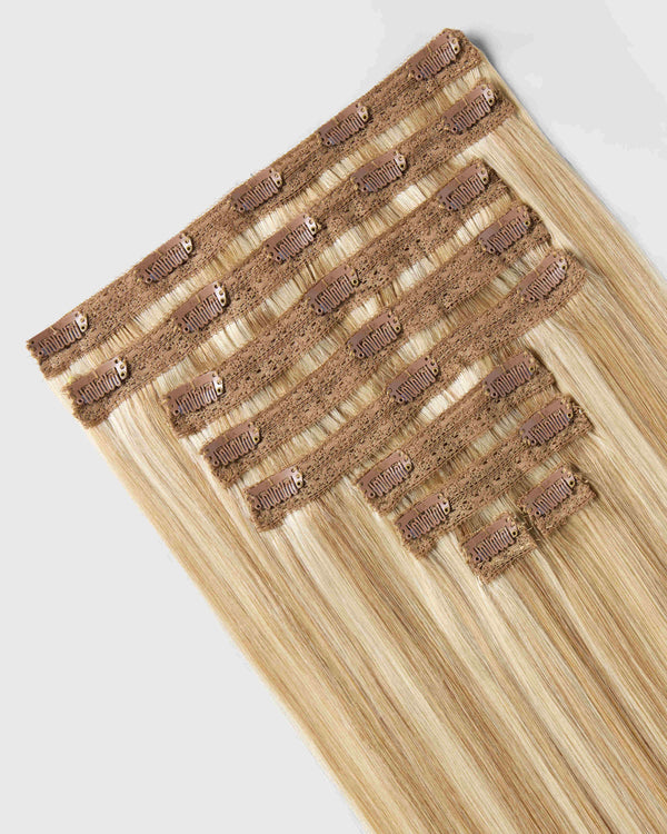A clip-in hair extension in Honey Beach Blonde showcasing a vibrant and natural look for enhanced hairstyle versatility.