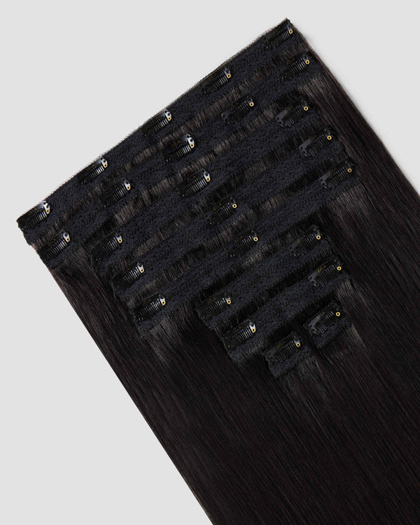 Clip-in hair extensions in black are designed to blend naturally with black hair for added volume and length.