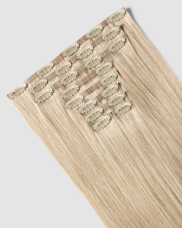 A set of clip-in champagne blonde hair extensions, highlighting their luxurious texture and natural appearance.