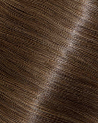 A close-up of straight, shiny, medium brown hair strands with natural highlights.