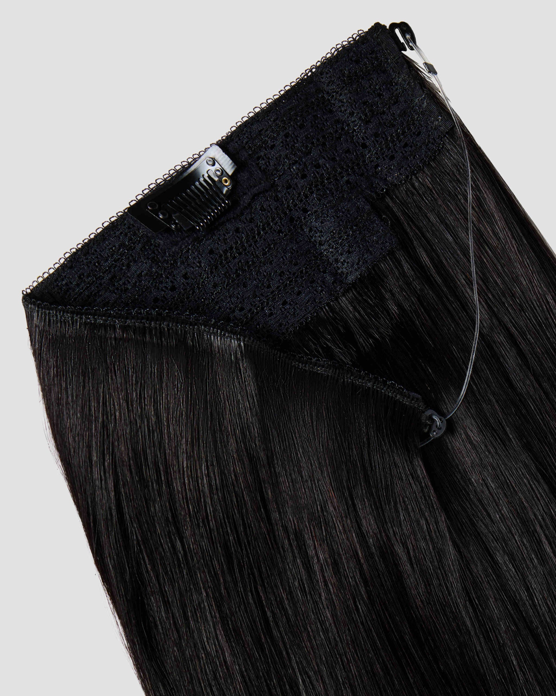 A halo black hair extension showing the wire and clips for effortless styling and secure attachment.