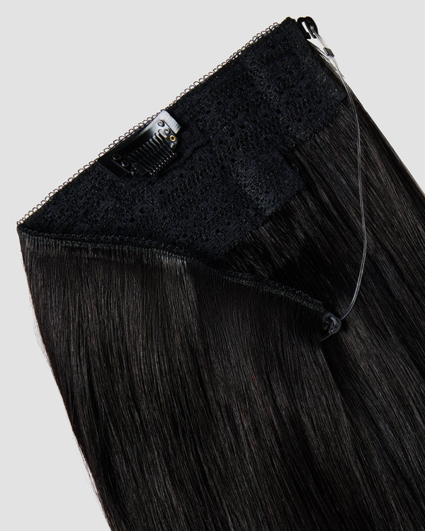 A halo black hair extension showing the wire and clips for effortless styling and secure attachment against a white background.
