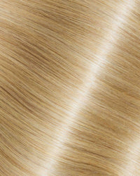 A detailed view of blonde hair texture featuring Iced Almond Latte extensions.