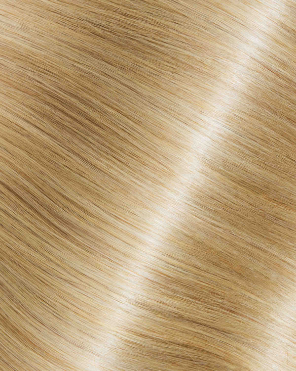 A detailed view of blonde hair texture featuring Iced Almond Latte extensions.