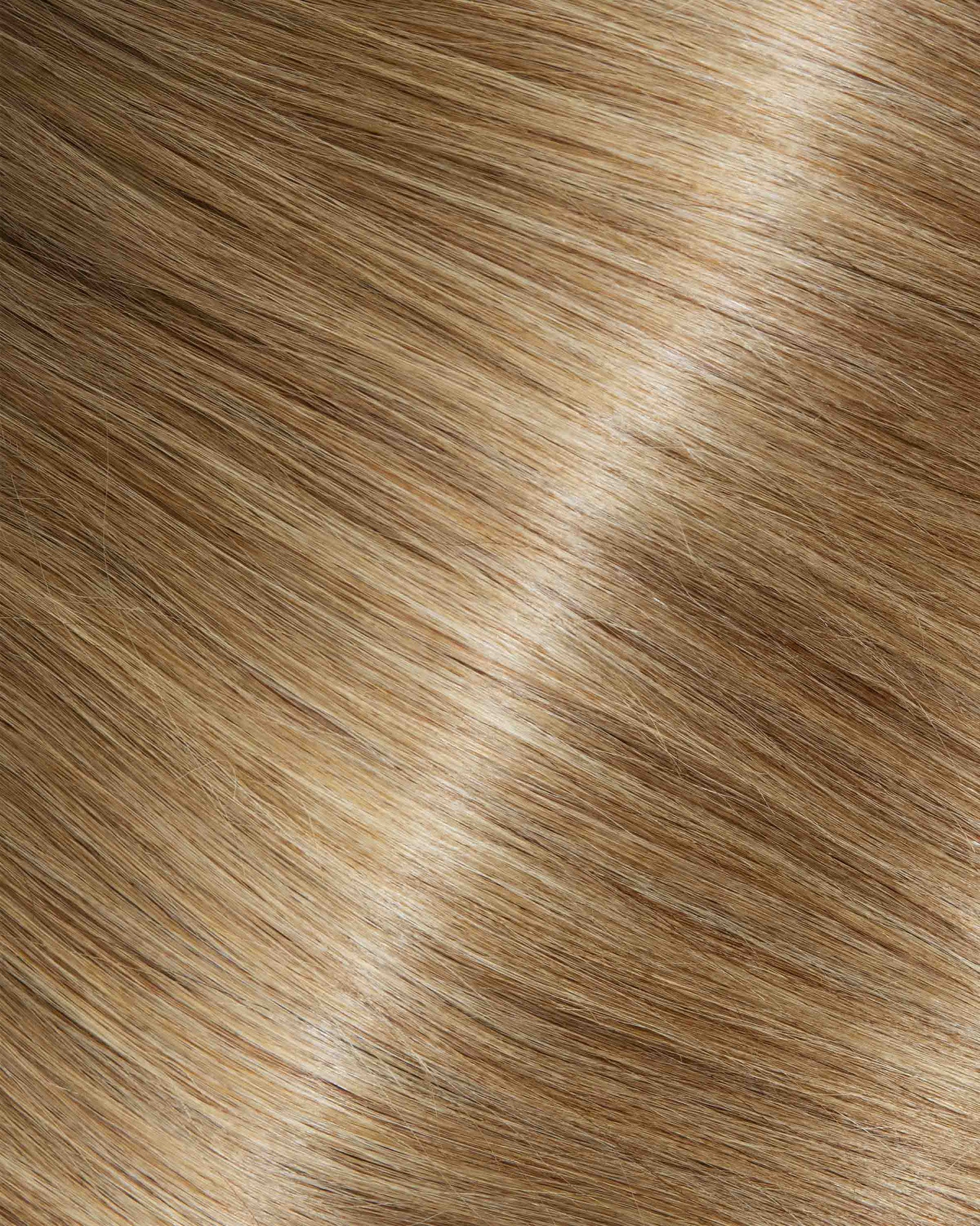 A swatch of mocha swirl hair extensions featuring long, wavy strands, showcasing their texture and shine.