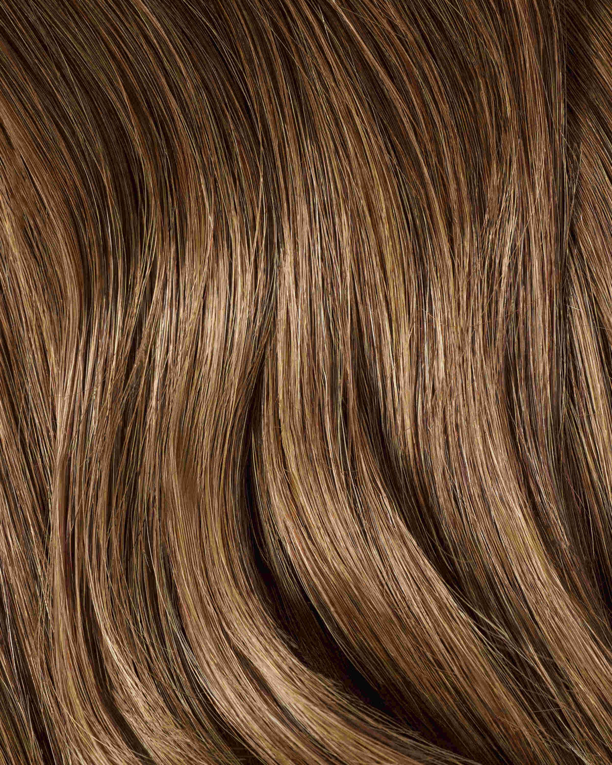 A swatch of rich cinnamon brown hair extensions with vibrant texture.