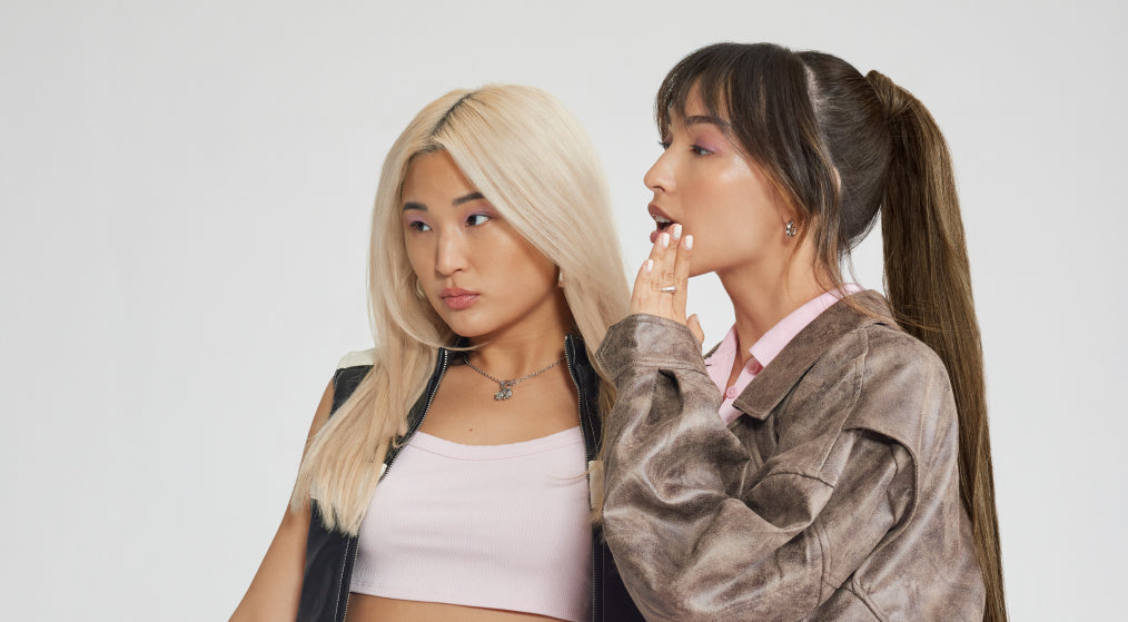 Two women wearing leather jackets and pink tops, showcasing stylish hair extensions and fashionable dresses.