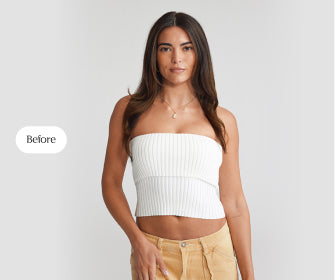 A woman in a white top and tan pants, showcasing her natural hair before applying hair extensions.