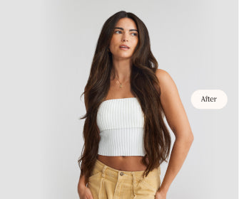 A woman in a crop top and khaki pants, showcasing her hair extensions and stylish outfit.