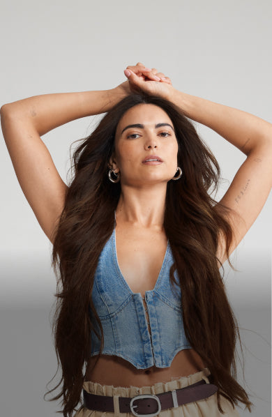 A woman with long, flowing hair and a bright smile showcasing her beautiful hair extensions.