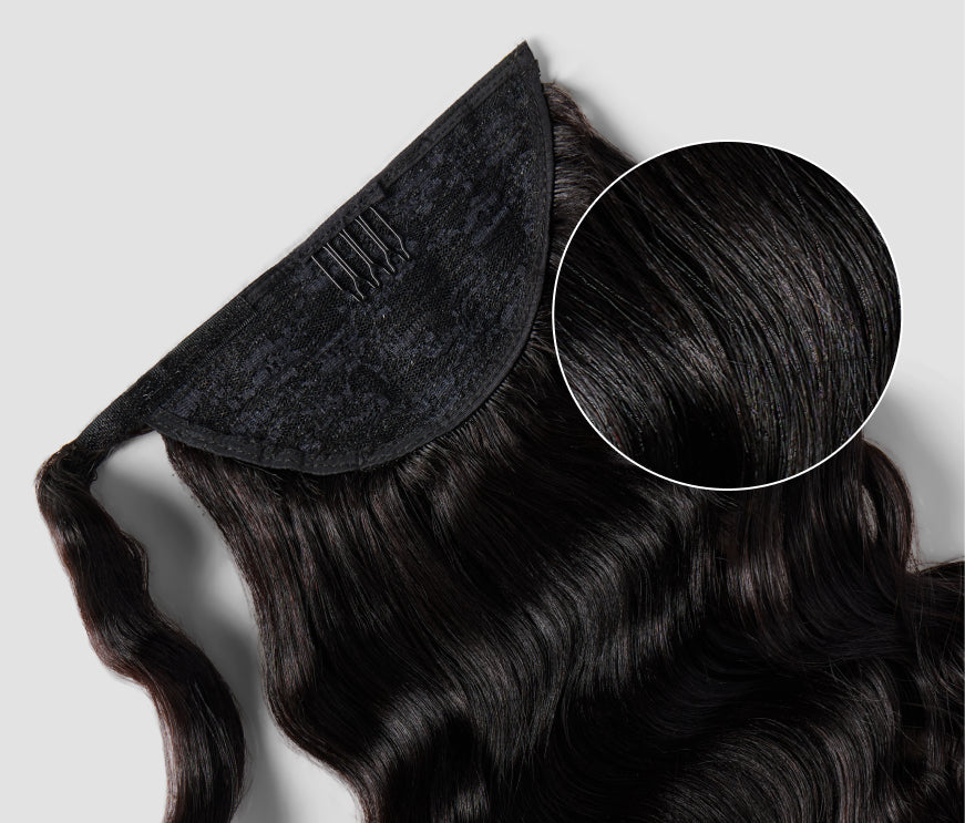 A black hair pin attached to the inside of a clip-in ponytail hair extensions showcases a stylish and elegant appearance.