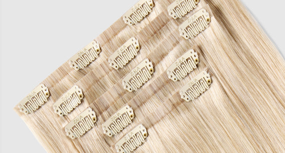 A set of clip-in hair extensions on a white background highlights their natural look and convenience for styling.