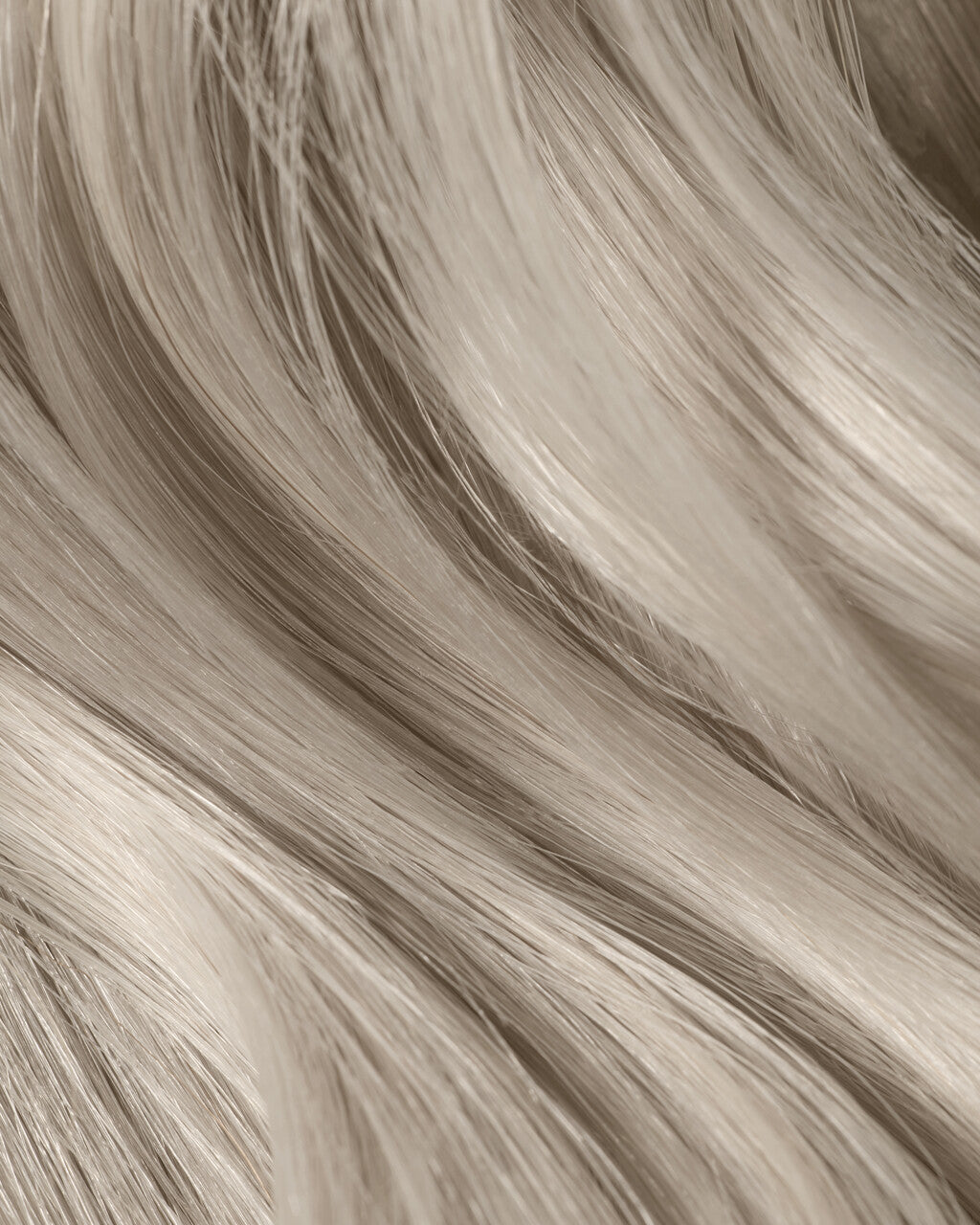A close-up of long, ice queen platinum hair extensions, showcasing their luxurious shine and silky texture.