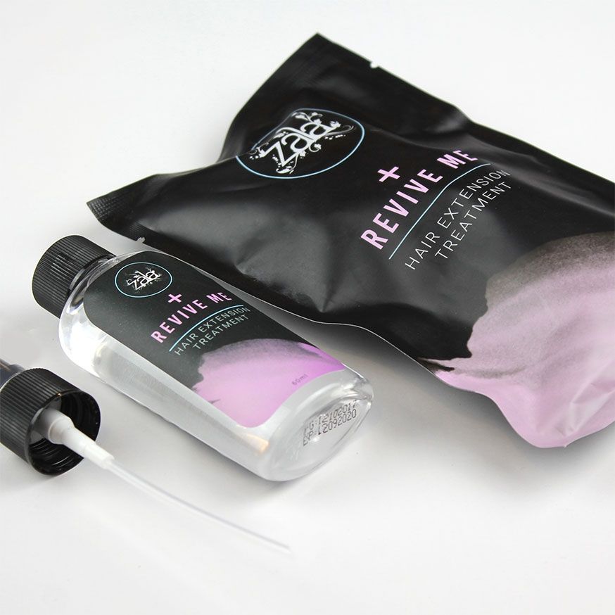 A "Revive Me" hair extension treatment kit with bottle, pump, and black pouch featuring purple gradient design.
