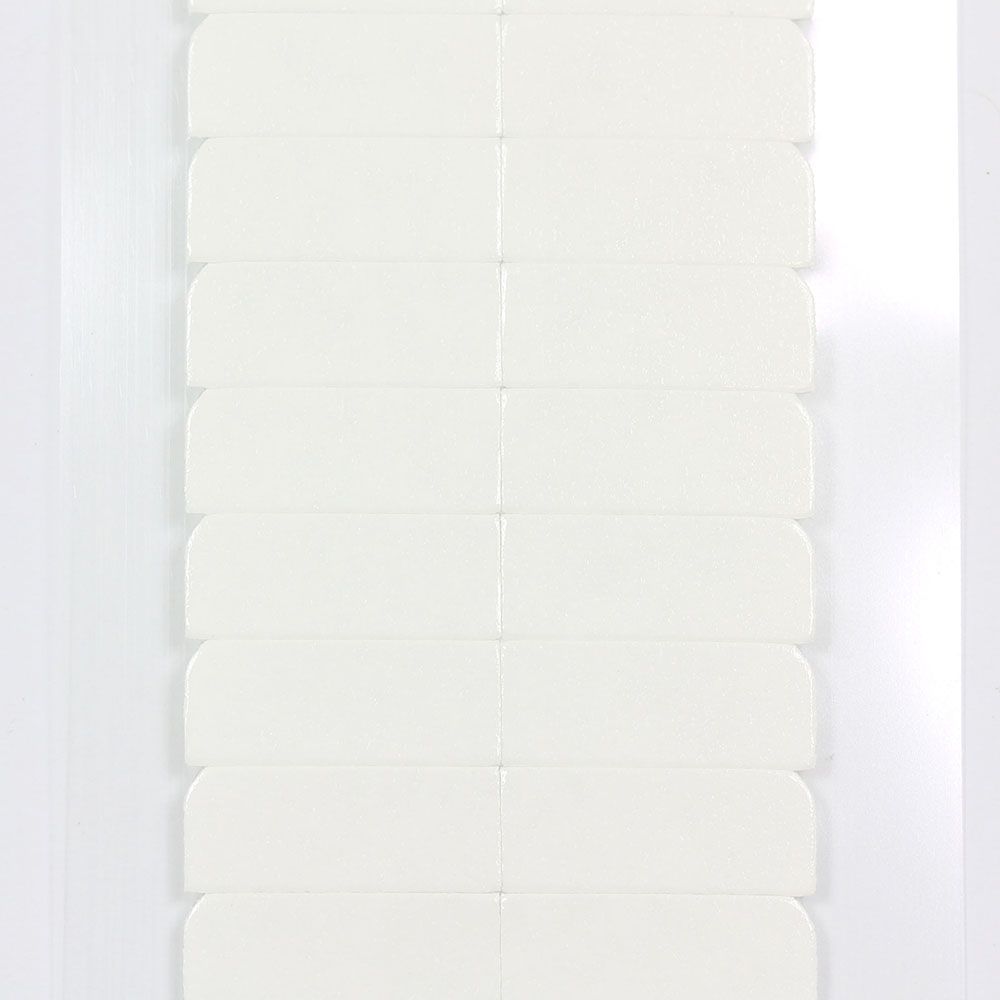 A sheet of double-sided white adhesive replacement tape tabs arranged in rows for hair extensions.