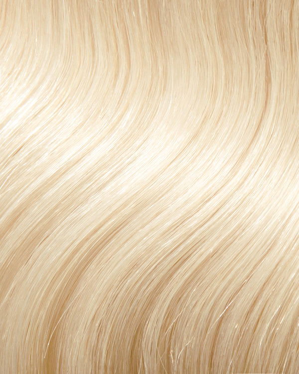 A close-up of wavy honey blonde hair extensions, showcasing soft, light blonde strands with a natural shine.