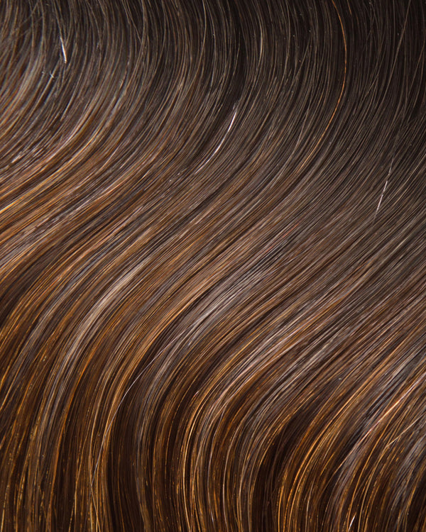 A close-up of a hair swatch featuring brown and black streaks, showcasing the texture and shine of hair extensions.