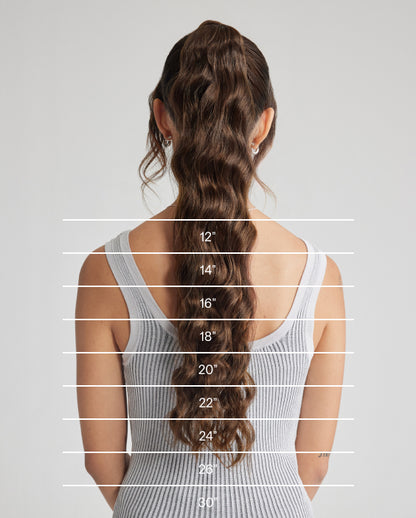 A close-up image showcasing the length of a woman's hair, highlighting the beauty of hair extensions. 