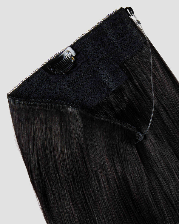 A halo black hair extension showing the wire and clips for effortless styling and secure attachment. 