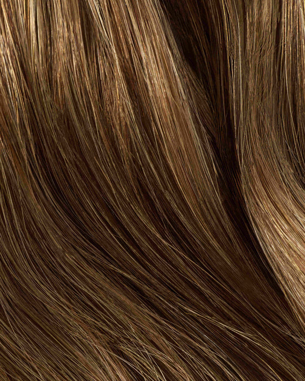 A swatch of hair featuring brown highlights, showcasing a swatch of caramel hair extension for added dimension.