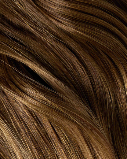 A swatch of hair featuring chestnut dirty extensions with brown and blonde highlights.