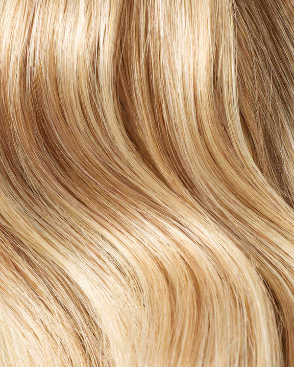 A swatch of a honey beach blonde color for hair extensions, showcasing its vibrant color and texture.