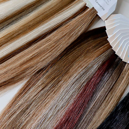 Two swatch rings of a variety of Zala Premium Hair Extensions in multiple colors, highlighting their texture and quality.