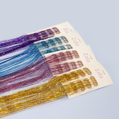 Four colorful tinsel hair extensions are displayed together, featuring shades of purple, blue, pink, and yellow.